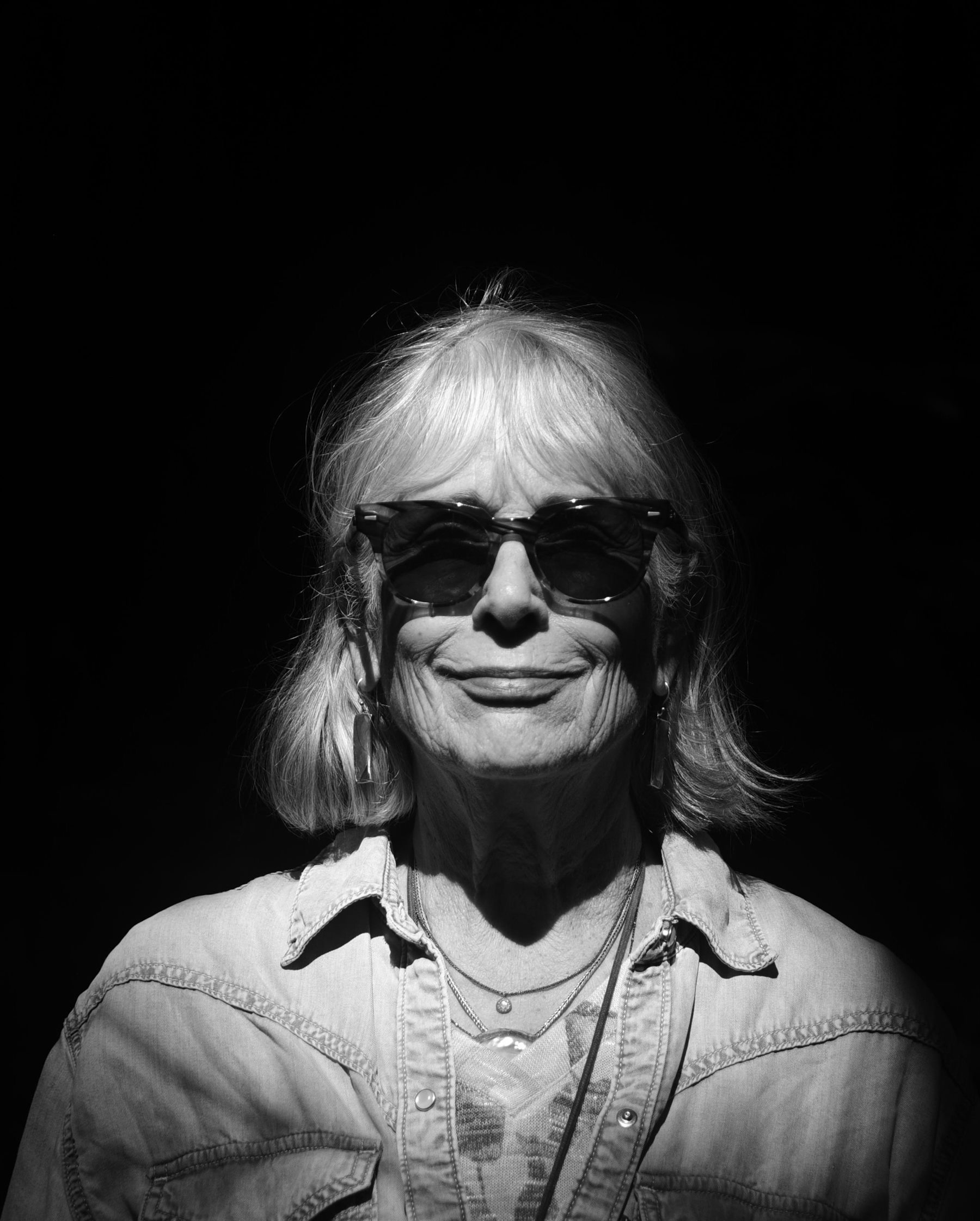 Black-and-white portrait of Cathryn Shea in sunglasses