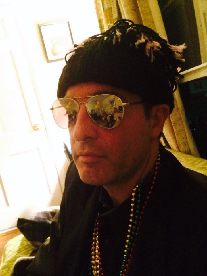 Louis Bourgeois in a knit cap, sunglasses, and beads