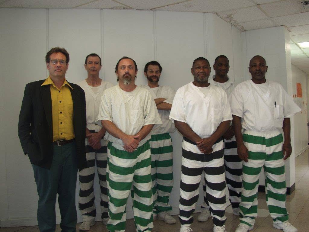 Louis Bourgeois standing with incarcerated writers in striped uniforms